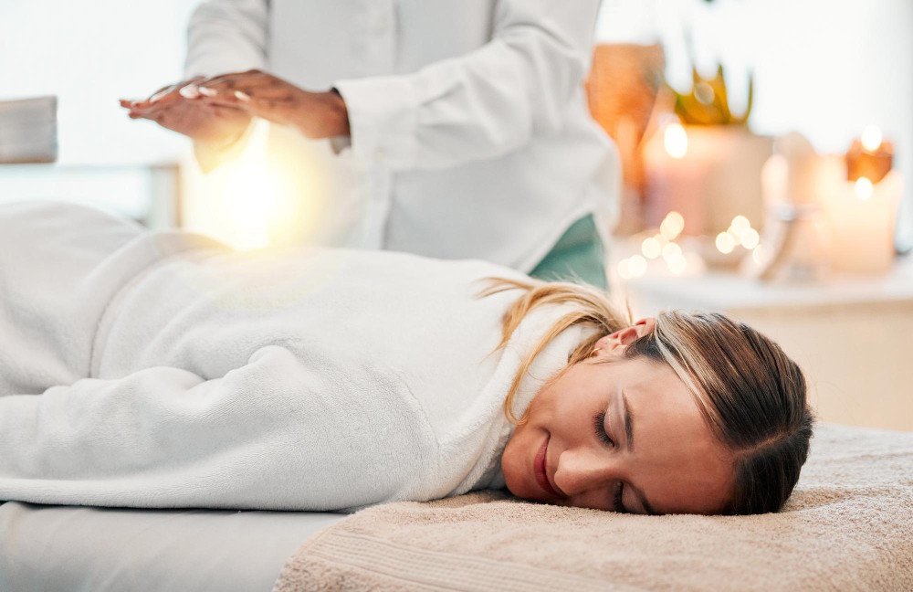 Female energy healer sending energy through the palms of her hands to another woman